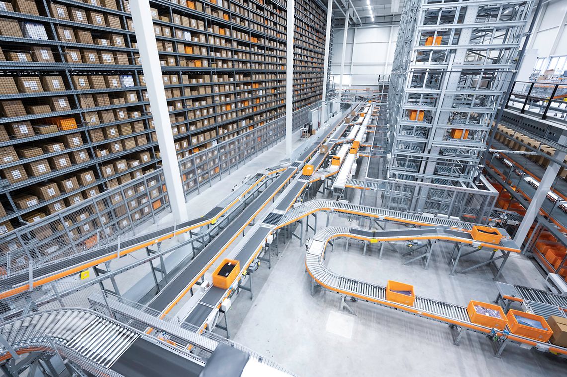 Automated warehouse with high-bay racking, ASRS towers and conveyor sortation loops